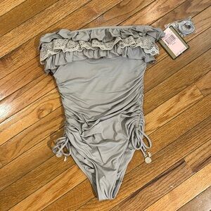 Juicy Couture Ruffled One piece with ruched sides and tie details.